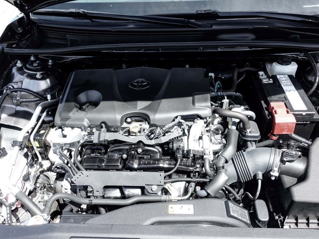 Toyota engine and battery under hood.