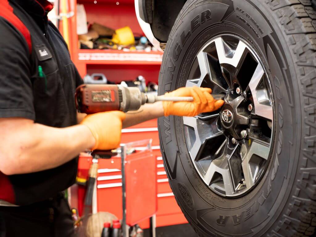 Toyota technician working on vehicle tires.