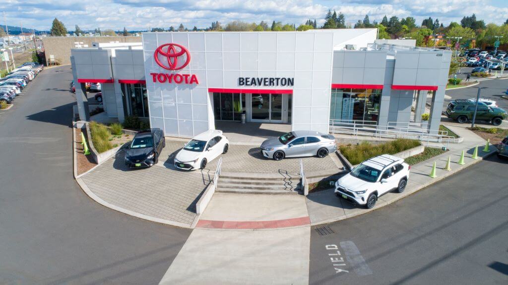 Aerial view of Beaverton Toyota dealership building with Toyotas out front.