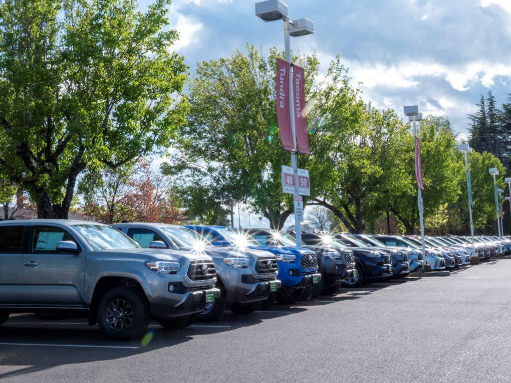 Row of Toyota vehicles for sale in Beaverton Toyota car lot.