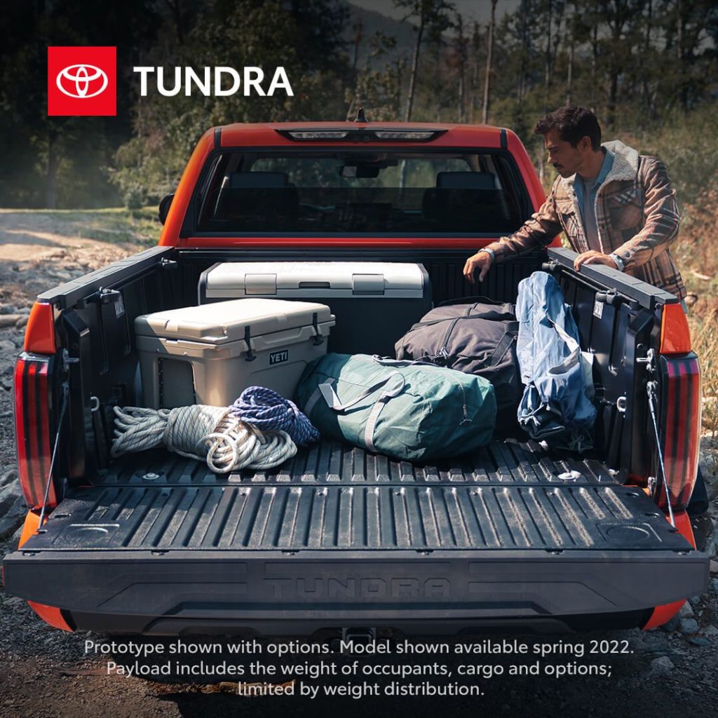 Orange Toyota Tundra bed with camping gear.